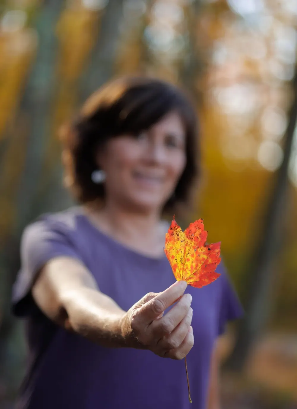 Tiffany Chan holding an autumn leaf